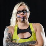 Val Kyrie with warrior face makeup on looking at the camera