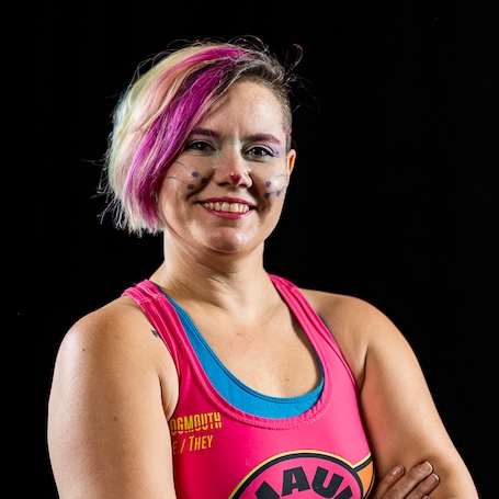 Kid Vicious smiling at the camera with pink streak in hair